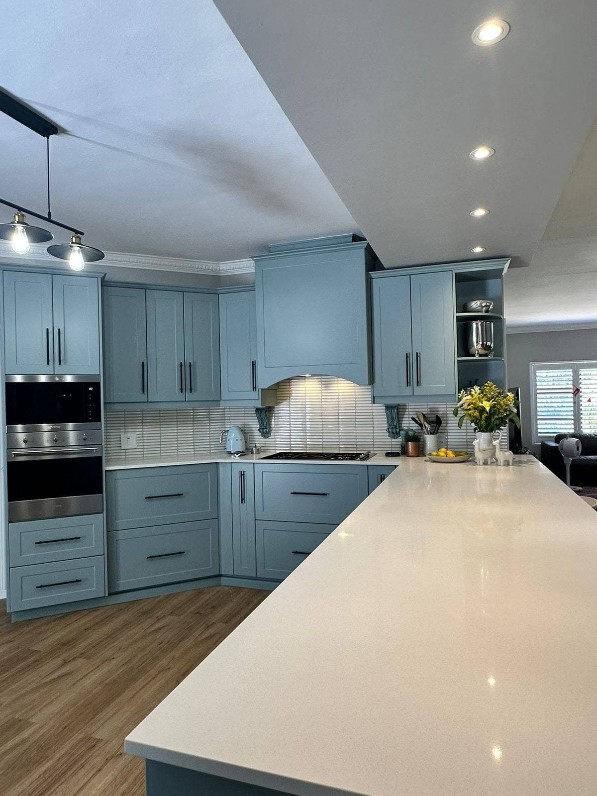 A fitted grey kitchen with a stone island made by MD Cabinets
